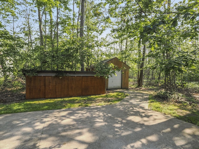 6552 High Trees Ct, Gaylord, MI 49735 - view of property exterior with driveway, an outbuilding, and a garage