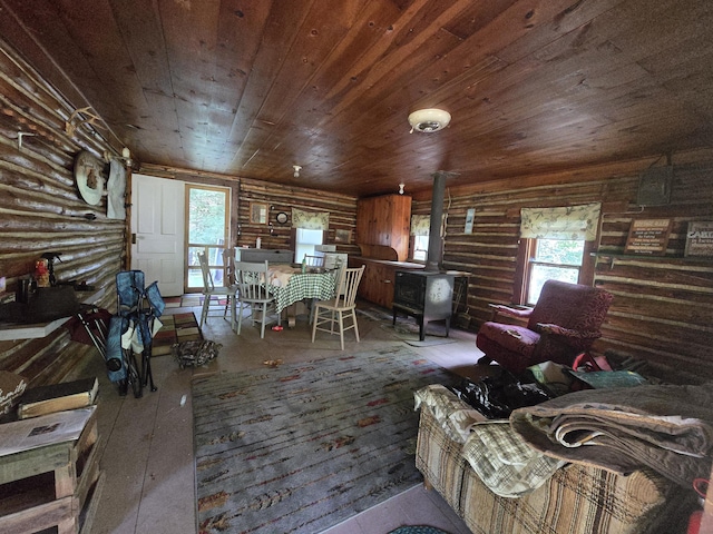 899 Bills Rd, Mio, MI 48647 - living area with rustic walls, wooden ceiling, hardwood / wood-style floors, and a wood stove