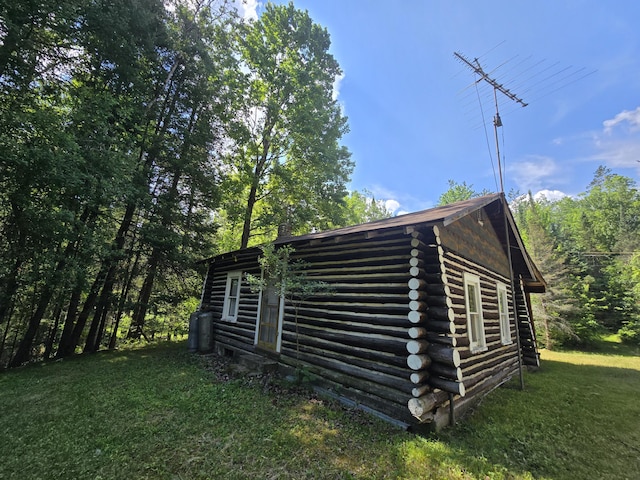 899 Bills Rd, Mio, MI 48647 - view of side of home featuring log exterior and a lawn
