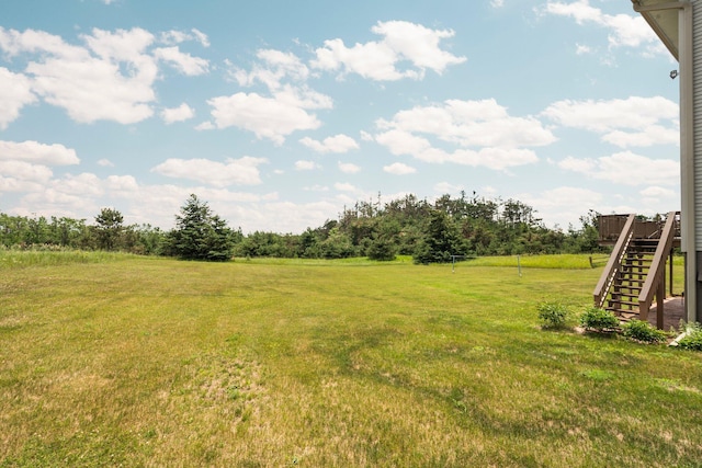 2829 Kassuba Rd, Gaylord, MI 49735 - view of green lawn featuring stairway and a deck