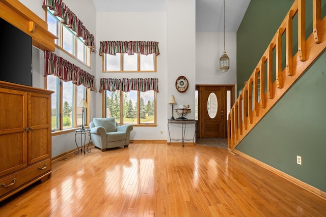2829 Kassuba Rd, Gaylord, MI 49735 - foyer featuring stairway, a towering ceiling, and light wood-style flooring