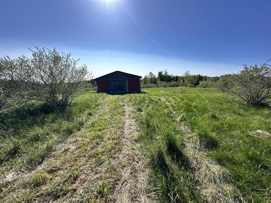 605 N Poor Farm Rd, Harrisville, MI 48740 - view of yard featuring an outdoor structure, a pole building, and a view of countryside
