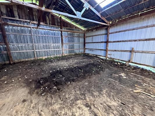 605 N Poor Farm Rd, Harrisville, MI 48740 - garage with metal wall