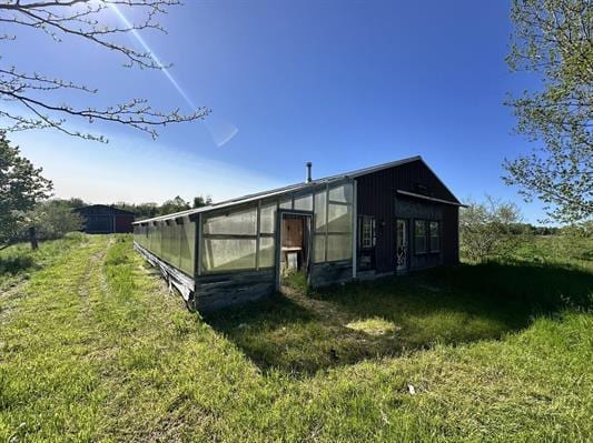 605 N Poor Farm Rd, Harrisville, MI 48740 - view of greenhouse with a lawn