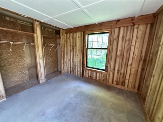 605 N Poor Farm Rd, Harrisville, MI 48740 - unfurnished bedroom with two closets and concrete flooring