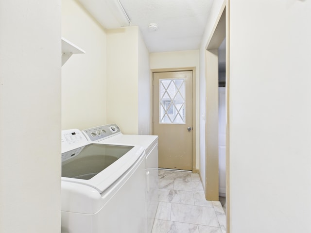 5589 Algonquin Rd, Gaylord, MI 49735 - laundry area with independent washer and dryer and light marble finish flooring