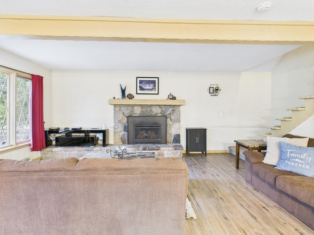 5589 Algonquin Rd, Gaylord, MI 49735 - living room with wood finished floors, a fireplace, and stairs