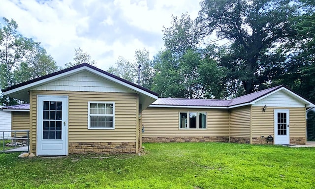 6416 Jimary Ln, Gladwin, MI 48624 - back of property featuring a yard and a metal roof