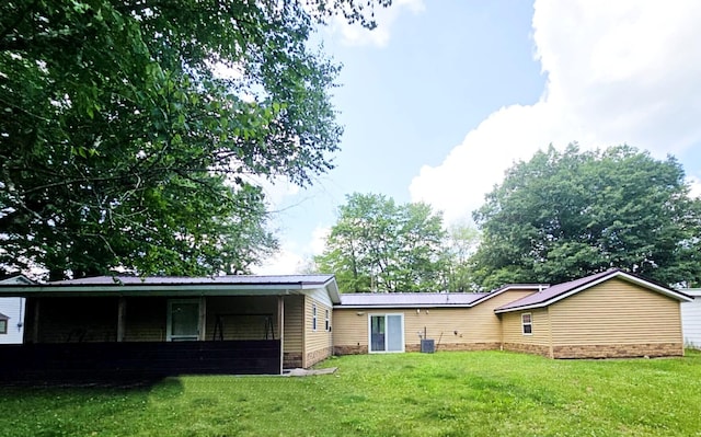 6416 Jimary Ln, Gladwin, MI 48624 - rear view of property featuring a yard
