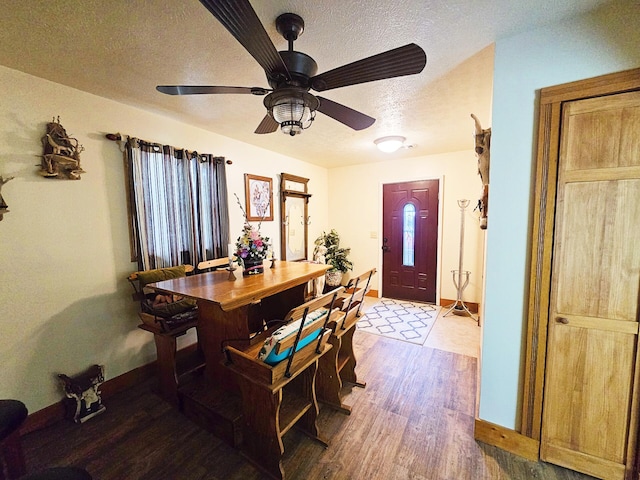 6416 Jimary Ln, Gladwin, MI 48624 - dining area featuring a textured ceiling, wood finished floors, and ceiling fan