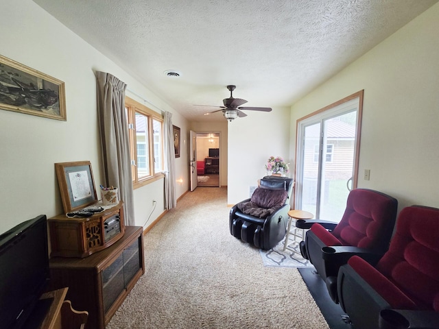 6416 Jimary Ln, Gladwin, MI 48624 - carpeted living area with ceiling fan and a textured ceiling