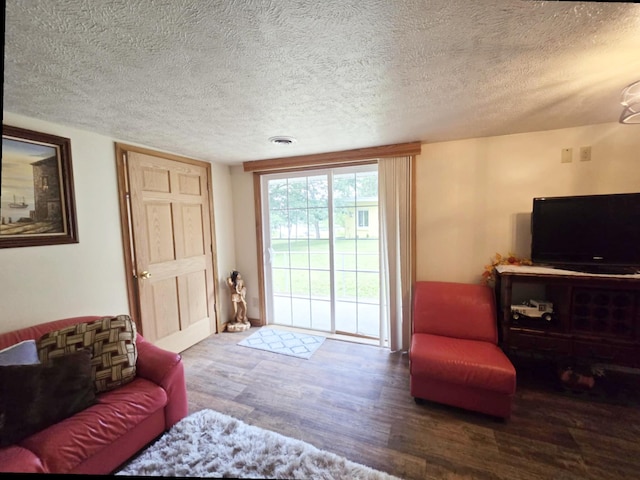 6416 Jimary Ln, Gladwin, MI 48624 - living area with wood finished floors and a textured ceiling