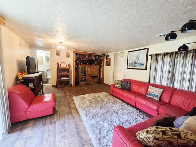 6416 Jimary Ln, Gladwin, MI 48624 - living room with a textured ceiling and wood finished floors