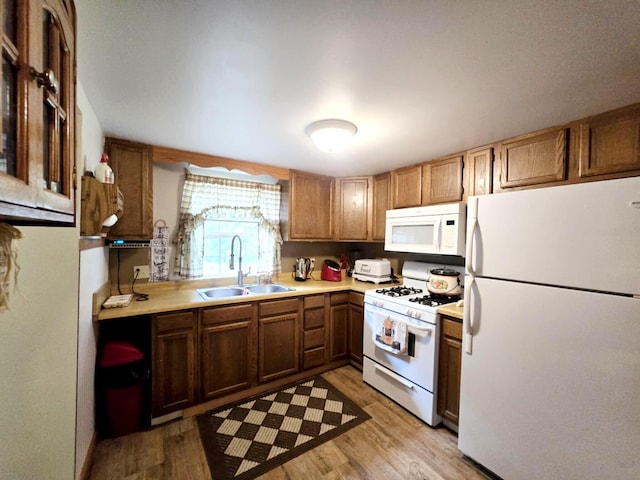 6416 Jimary Ln, Gladwin, MI 48624 - kitchen with white appliances, light countertops, light wood finished floors, and brown cabinets