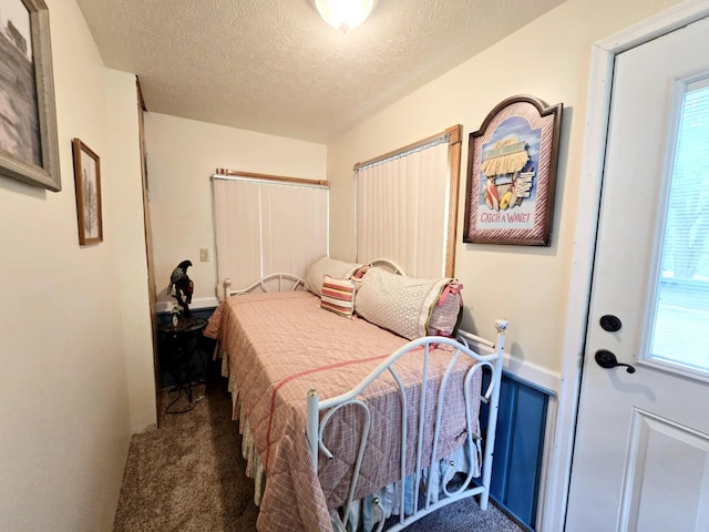 6416 Jimary Ln, Gladwin, MI 48624 - carpeted bedroom with a textured ceiling and multiple windows