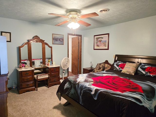 6416 Jimary Ln, Gladwin, MI 48624 - bedroom with light colored carpet, a textured ceiling, and ceiling fan