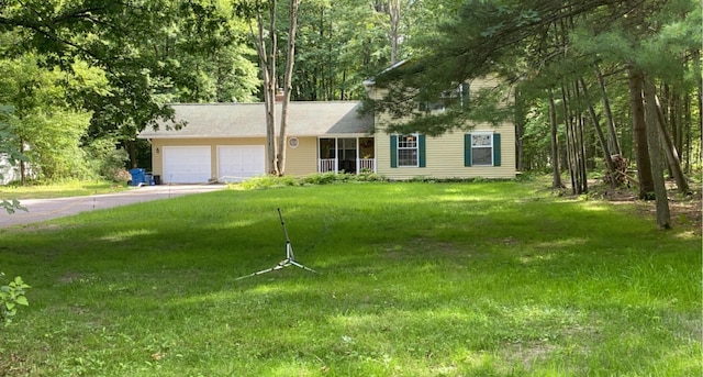6119 W Nestel Rd, Houghton Lake, MI 48629 - view of front of property with an attached garage, a front yard, and driveway