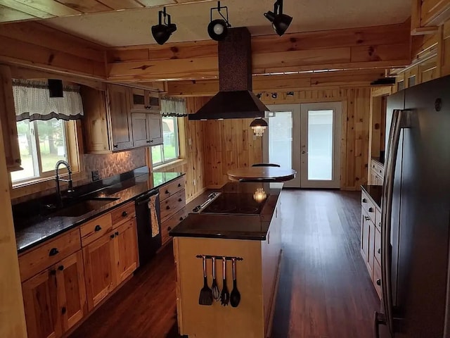 117 Vienna Ct, Houghton Lake, MI 48629 - kitchen with freestanding refrigerator, dishwasher, island exhaust hood, dark countertops, and cooktop