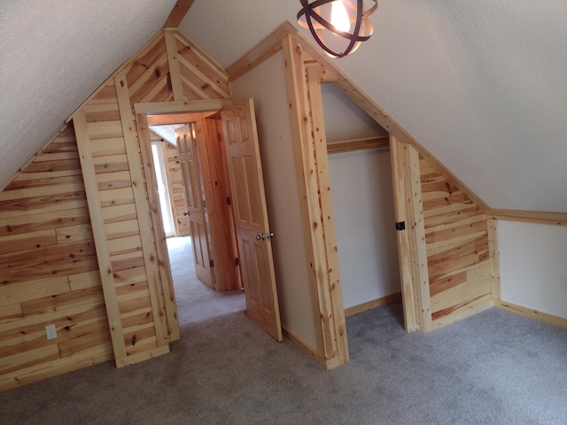 117 Vienna Ct, Houghton Lake, MI 48629 - bonus room featuring wooden walls, vaulted ceiling, and carpet flooring