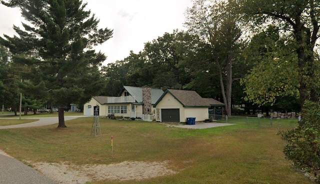 117 Vienna Ct, Houghton Lake, MI 48629 - view of front of home featuring a garage and driveway