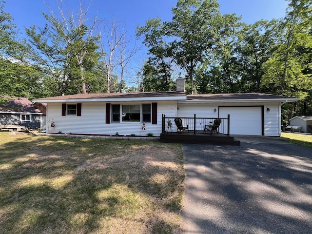 332 Pingree St, Roscommon, MI 48653 - ranch-style house featuring a garage, a chimney, asphalt driveway, a front yard, and a wooden deck