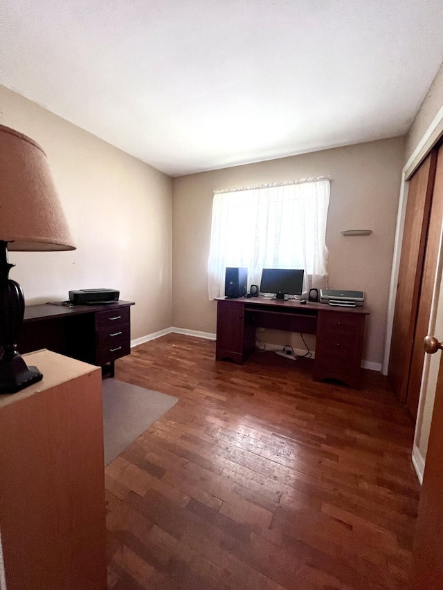 1003 Ada St, Owosso, MI 48867 - office area featuring dark wood-style flooring and baseboards