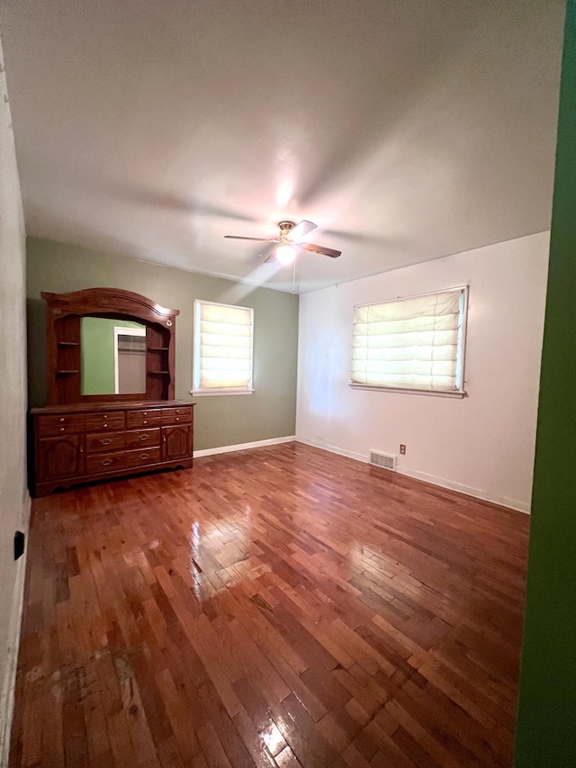 1003 Ada St, Owosso, MI 48867 - unfurnished bedroom featuring hardwood / wood-style floors and a ceiling fan