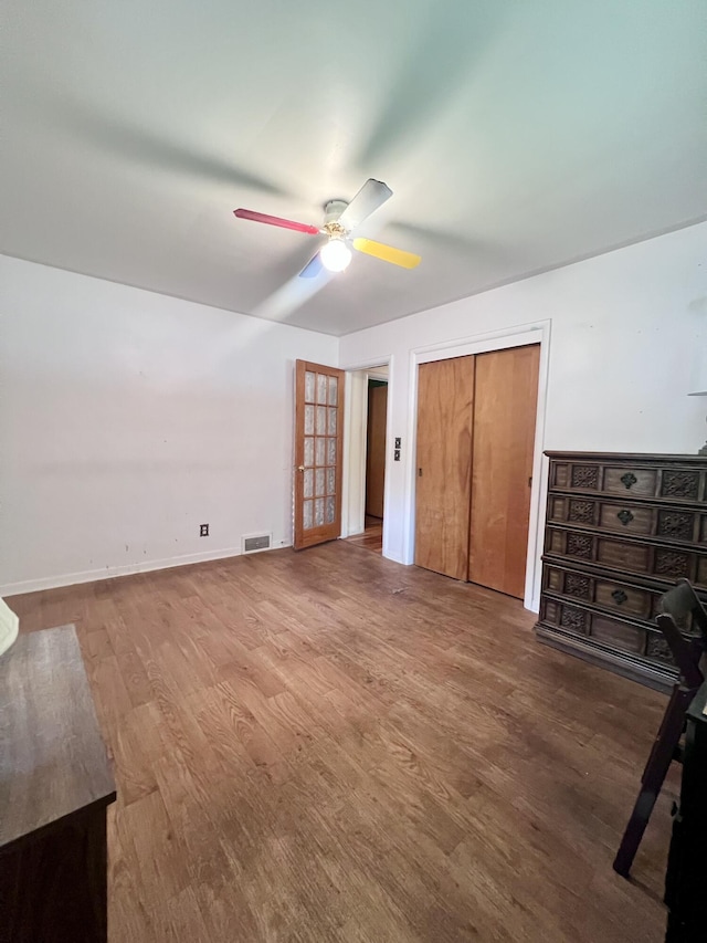 1003 Ada St, Owosso, MI 48867 - unfurnished bedroom featuring wood finished floors, a closet, and ceiling fan