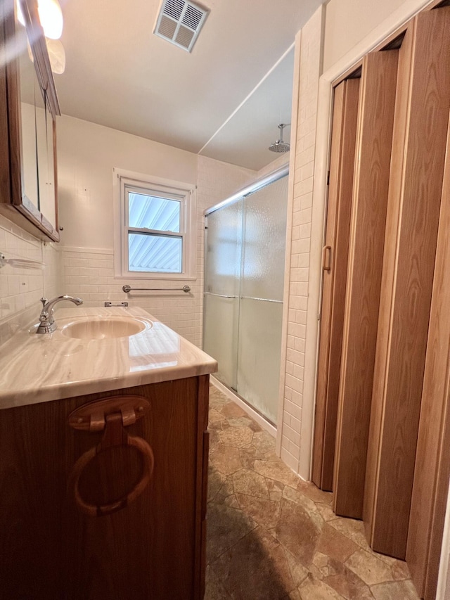 1003 Ada St, Owosso, MI 48867 - bathroom with a shower stall, stone finish floors, and vanity