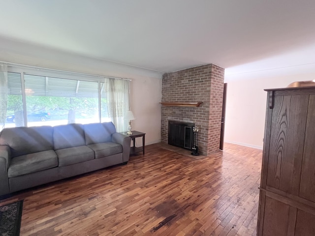 1003 Ada St, Owosso, MI 48867 - living area with wood finished floors and a brick fireplace