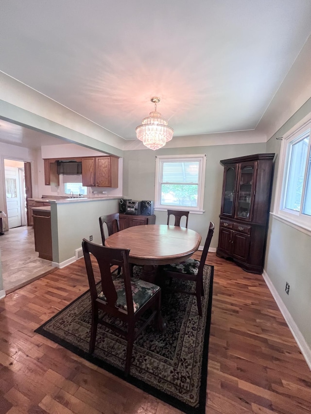 1003 Ada St, Owosso, MI 48867 - dining area with a chandelier, wood finished floors, and healthy amount of natural light