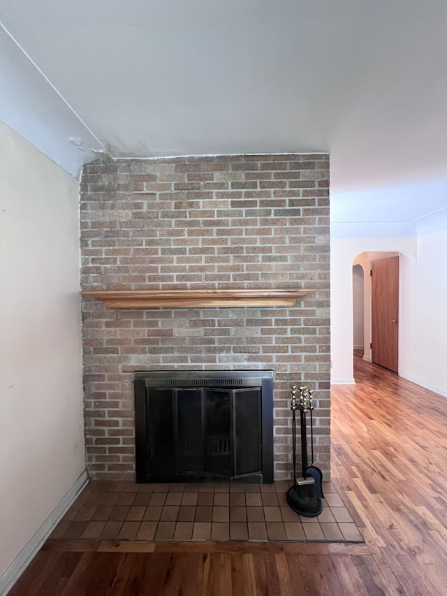 1003 Ada St, Owosso, MI 48867 - detailed view of a fireplace, wood finished floors, and arched walkways