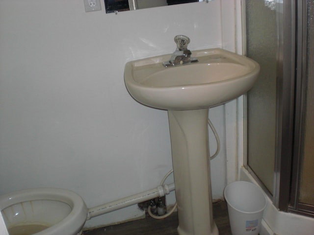 557 Davis St, Lake, MI 48632 - full bath with a shower stall and wood finished floors