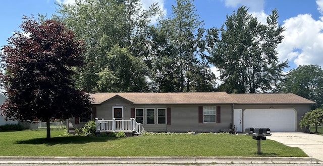 362 N Addison St, Alpena, MI 49707 - single story home featuring concrete driveway, an attached garage, and a front yard