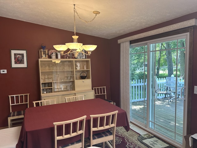 362 N Addison St, Alpena, MI 49707 - dining space with a textured ceiling and a chandelier