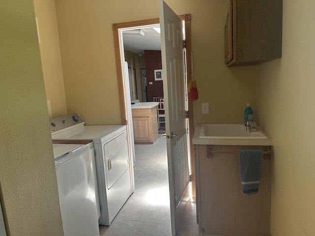 362 N Addison St, Alpena, MI 49707 - laundry room with separate washer and dryer, cabinet space, and light tile patterned floors