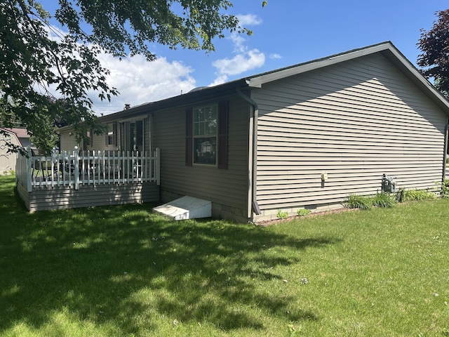362 N Addison St, Alpena, MI 49707 - view of side of home featuring crawl space, a wooden deck, and a yard