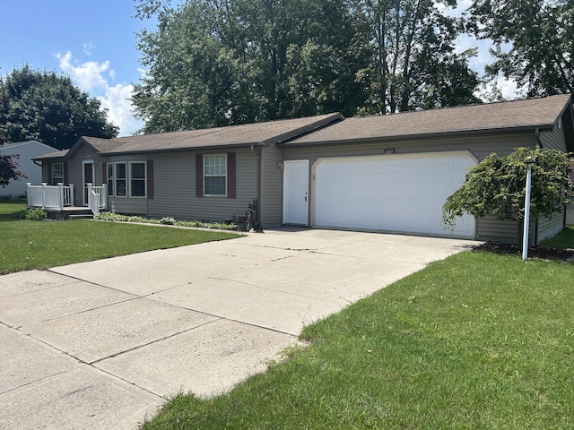 362 N Addison St, Alpena, MI 49707 - ranch-style home featuring a garage, concrete driveway, a front yard, and a shingled roof