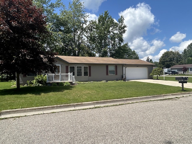 362 N Addison St, Alpena, MI 49707 - ranch-style home featuring concrete driveway, a front yard, and a garage
