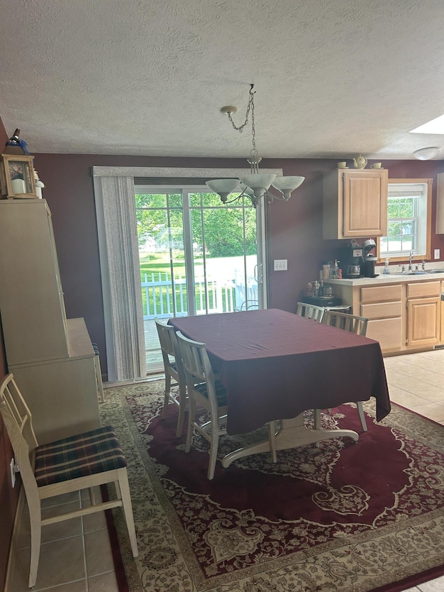 362 N Addison St, Alpena, MI 49707 - dining room with a textured ceiling and light tile patterned floors