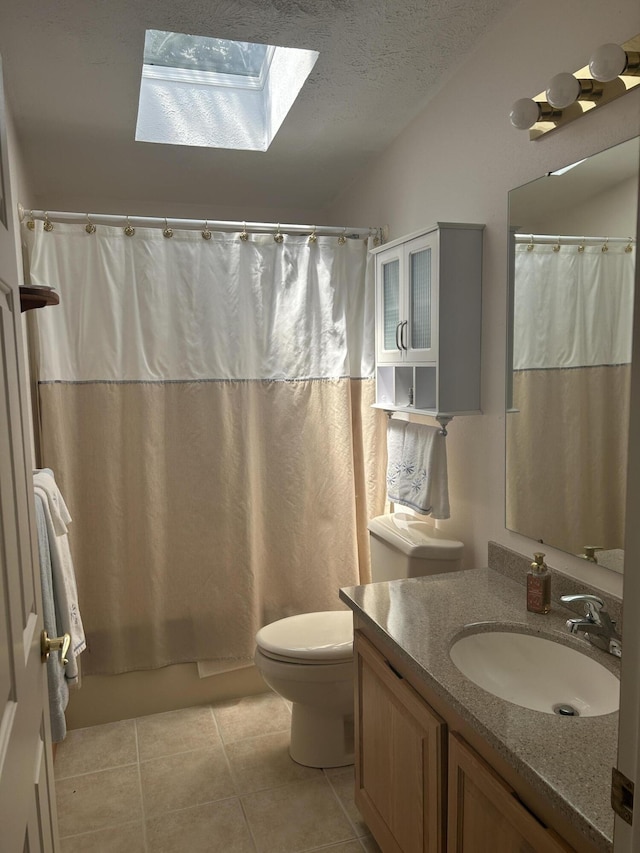 362 N Addison St, Alpena, MI 49707 - full bath with a skylight, vanity, tile patterned flooring, and a textured ceiling