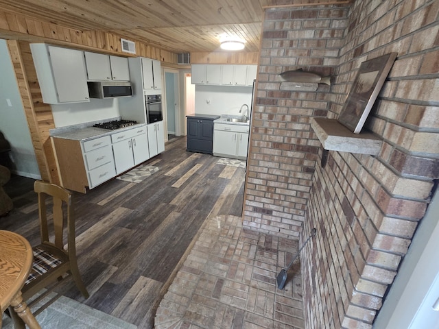 1300 Geesey Ave, Mio, MI 48647 - kitchen with appliances with stainless steel finishes, wooden ceiling, white cabinets, and light countertops