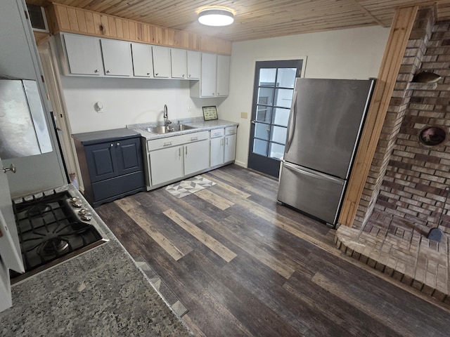 1300 Geesey Ave, Mio, MI 48647 - kitchen with stainless steel appliances, white cabinets, dark wood finished floors, wooden ceiling, and light countertops