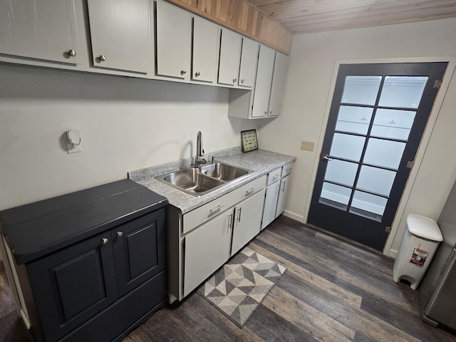 1300 Geesey Ave, Mio, MI 48647 - kitchen with dark wood-style flooring, white cabinets, and light countertops