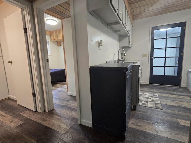 1300 Geesey Ave, Mio, MI 48647 - kitchen featuring dark wood-style floors, white cabinetry, and wooden ceiling