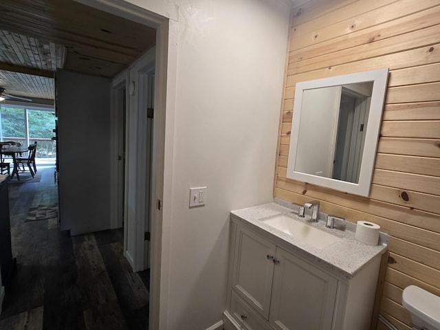 1300 Geesey Ave, Mio, MI 48647 - bathroom featuring vanity, wood finished floors, wooden walls, and wood ceiling