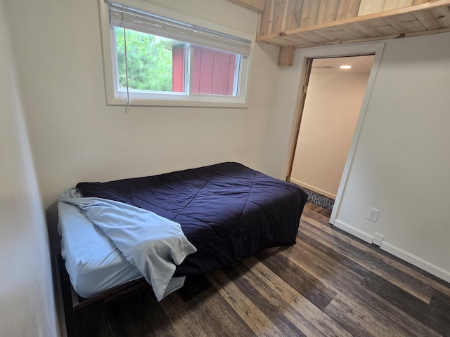 1300 Geesey Ave, Mio, MI 48647 - bedroom featuring dark wood-type flooring and baseboards