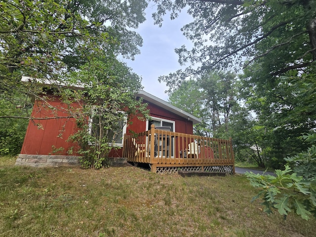 1300 Geesey Ave, Mio, MI 48647 - rear view of house featuring a wooden deck and a lawn
