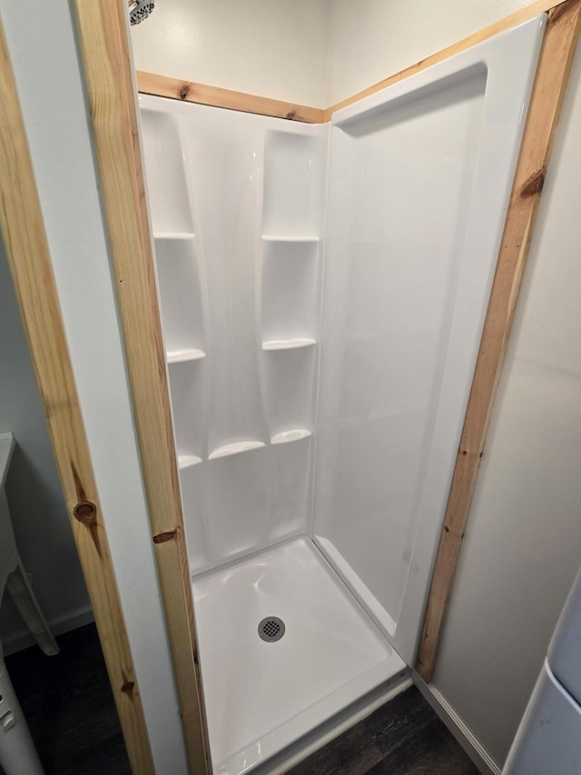 1300 Geesey Ave, Mio, MI 48647 - bathroom featuring a shower stall and wood finished floors