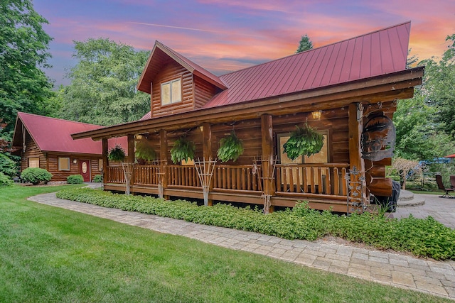 23 Treasure Is, Roscommon, MI 48653 - cabin with covered porch, log exterior, a metal roof, and a lawn